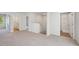 Upstairs landing with neutral carpet flooring, closet, laundry room, and bathroom access at 11857 Rizvan Pl, Covington, GA 30014