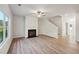 Cozy living room with fireplace, ceiling fan, and stairway to the second floor at 11857 Rizvan Pl, Covington, GA 30014
