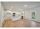 Open concept living room and kitchen area with wood floors and lots of natural light at 11857 Rizvan Pl, Covington, GA 30014