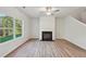 Bright living room with fireplace and large windows showing a lush green yard at 11857 Rizvan Pl, Covington, GA 30014
