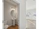 Contemporary half-bathroom with pedestal sink, oval mirror and wood look flooring at 11857 Rizvan Pl, Covington, GA 30014