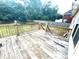 A backyard deck overlooks a yard with mature trees, framed by a wooden fence for privacy at 350 Glynnshire Ct, Covington, GA 30016