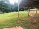 Spacious, verdant backyard under a deck featuring scattered leaves and a basketball hoop at 350 Glynnshire Ct, Covington, GA 30016