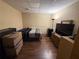 Furnished basement bedroom with a bed, storage boxes, television, dresser, and wood-look flooring at 350 Glynnshire Ct, Covington, GA 30016