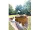 Flooded backyard basketball court surrounded by a tall wooden fence and mature trees at 350 Glynnshire Ct, Covington, GA 30016