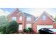 Lovely two-story brick home with well-maintained landscaping and an attached two-car garage at 350 Glynnshire Ct, Covington, GA 30016