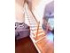 Staircase featuring white wood trim, hardwood stairs and a view into the living room at 350 Glynnshire Ct, Covington, GA 30016