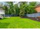 A spacious backyard with room for outdoor activities and entertainment with a wooded background at 505 Junction Pt, Roswell, GA 30075