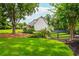 A lush green backyard with a fenced perimeter and mature trees adds privacy to the property at 505 Junction Pt, Roswell, GA 30075