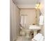 This bathroom features hexagon tile flooring and a pedestal sink with overhead lighting at 505 Junction Pt, Roswell, GA 30075