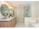 Bright bathroom boasts double sinks, a glass-enclosed shower, and a luxurious soaking tub at 505 Junction Pt, Roswell, GA 30075
