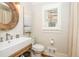 Charming bathroom with a rustic wood-framed mirror, and a bright window with plantation shutters at 505 Junction Pt, Roswell, GA 30075