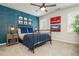 Cozy bedroom with blue accent wall, ceiling fan, and decorative wall art at 505 Junction Pt, Roswell, GA 30075