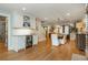 Open-concept dining room with a wine fridge, access to a staircase, a modern lighting fixture, and gleaming hardwood floors at 505 Junction Pt, Roswell, GA 30075