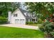 Charming home with a well-manicured lawn and a two-car garage with a long driveway at 505 Junction Pt, Roswell, GA 30075