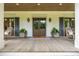 Charming front porch with rocking chairs flanking the entry, planters, and a beautiful stained wood ceiling at 505 Junction Pt, Roswell, GA 30075