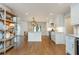 Bright and spacious kitchen featuring white cabinets, hardwood floors, an island, and modern appliances at 505 Junction Pt, Roswell, GA 30075