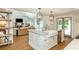Open kitchen featuring a farmhouse sink, stainless steel appliances, and hardwood floors at 505 Junction Pt, Roswell, GA 30075