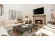 Inviting living room featuring a brick fireplace, a large flatscreen TV, and hardwood floors at 505 Junction Pt, Roswell, GA 30075