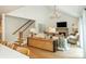Cozy living room with vaulted ceilings, brick fireplace, hardwood floors, and plenty of natural light at 505 Junction Pt, Roswell, GA 30075