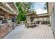 This outdoor kitchen features a built-in grill and is adjacent to a comfortable outdoor dining area at 505 Junction Pt, Roswell, GA 30075