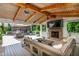 This outdoor living area features a cozy seating area, a fireplace, and an outdoor kitchen at 505 Junction Pt, Roswell, GA 30075