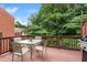 Relaxing back deck featuring a table with chairs and a grill, perfect for outdoor entertaining at 7863 Kiverton Pl, Atlanta, GA 30350