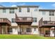 Back exterior of a multi-story home showcasing private decks and a well-maintained lawn at 7863 Kiverton Pl, Atlanta, GA 30350