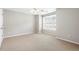 Bedroom with neutral colors, a ceiling fan, and a large window with wood blinds at 7863 Kiverton Pl, Atlanta, GA 30350