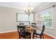 Cozy dining area with wood floors, a chandelier, and natural light at 7863 Kiverton Pl, Atlanta, GA 30350
