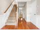 Inviting foyer featuring hardwood floors and a staircase at 7863 Kiverton Pl, Atlanta, GA 30350