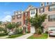 Charming brick townhome exterior with manicured landscaping, driveways, and a garage at 7863 Kiverton Pl, Atlanta, GA 30350
