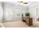 Home office with a wooden desk, a potted plant, a door, and a window with blinds at 7863 Kiverton Pl, Atlanta, GA 30350
