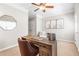 Home office with a wooden desk, a rolling chair, a mirror, and three wall pictures at 7863 Kiverton Pl, Atlanta, GA 30350
