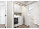 Efficient laundry area featuring a washer, dryer, and built-in storage for a tidy and functional space at 7863 Kiverton Pl, Atlanta, GA 30350