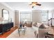 Sunlit living room boasts hardwood floors and views through bright windows at 7863 Kiverton Pl, Atlanta, GA 30350