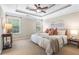 This beautiful main bedroom has a ceiling fan, two windows, and two bedside tables at 7863 Kiverton Pl, Atlanta, GA 30350