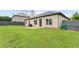 Large backyard with green lawn, privacy fence, and a cozy patio at 80 Pulaski Pl, Jonesboro, GA 30238