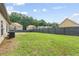 Expansive backyard featuring a lawn, mature trees, and a full privacy fence at 80 Pulaski Pl, Jonesboro, GA 30238