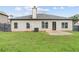 View of the backyard featuring a well-maintained lawn, a patio, and a privacy fence at 80 Pulaski Pl, Jonesboro, GA 30238