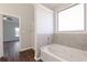 Bathroom with a jetted tub, shower and view into adjacent room at 80 Pulaski Pl, Jonesboro, GA 30238