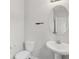 Stylish bathroom with a modern sink, round mirror and white toilet at 80 Pulaski Pl, Jonesboro, GA 30238
