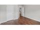 Bedroom with hardwood floors, neutral paint, and a view into another room at 80 Pulaski Pl, Jonesboro, GA 30238