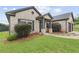 Inviting brick home featuring manicured bushes, a two-car garage, and a secure ADT security system at 80 Pulaski Pl, Jonesboro, GA 30238