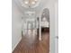 Elegant hallway with hardwood floors, arched doorways, and modern lighting at 80 Pulaski Pl, Jonesboro, GA 30238