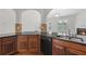 Stylish kitchen featuring dark cabinets, granite countertops, and an open layout at 80 Pulaski Pl, Jonesboro, GA 30238