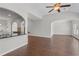 Open-concept living room showing wood floors and connection to the kitchen at 80 Pulaski Pl, Jonesboro, GA 30238