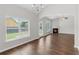 Living room features large windows, fireplace, and seamless flow into other rooms at 80 Pulaski Pl, Jonesboro, GA 30238