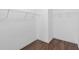 Spacious walk-in closet featuring built-in shelving and sleek, modern flooring at 80 Pulaski Pl, Jonesboro, GA 30238