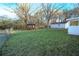 View of the backyard showing the covered gazebo, detached garage, and spacious lawn at 144 Morning Creek Rd, Jonesboro, GA 30238